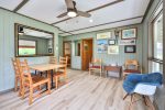 Dining area with wooden table and chairs in the Angler’s Cabin
