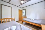 Bedroom with two single beds in the Angler’s Cabin