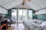 Bright living room with large glass doors opening to the lakefront porch.