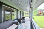 Covered porch with seating and views of Lac Heney.