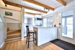 Open dining area with wood beams and large windows facing the lake.