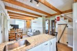 Open dining area with wood beams and large windows facing the lake.