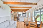 Bright living room with doors and windows facing the lakefront porch.