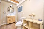 Bathroom vanity with storage and bright lighting.