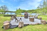 Outdoor firepit seating area overlooking Lac Heney