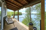 Lakeview Cabin upper deck with glass railing and outdoor seating.