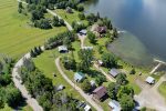 Aerial view of R&B Retreats showing cabins, boat launch, shoreline, and private lakefront property on Lac Heney.