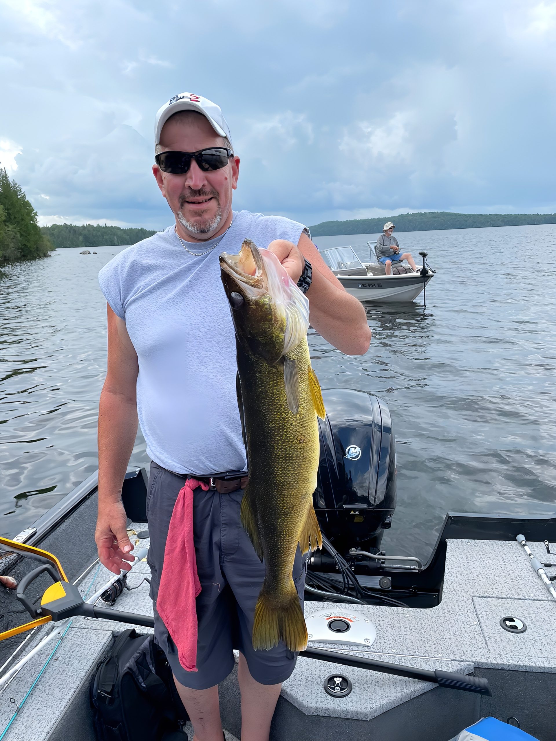 Angler lifting his catch beside the dock at R&B Retreats.